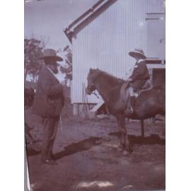 Unidentified man with bay on horseback