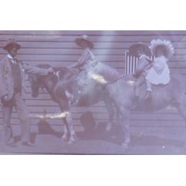 Unidentified children on horseback with man