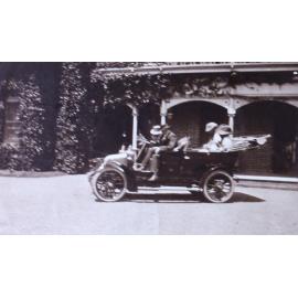 Unidentified men and women in a car