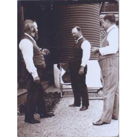 Three unidentified men near a tankstand
