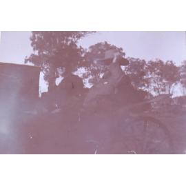 Unidentified man and woman in a buggy