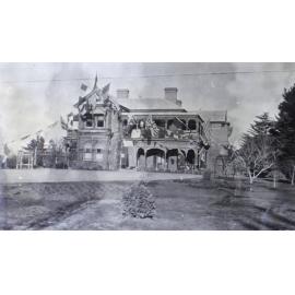 View of Saumarez Homestead covered with international flags