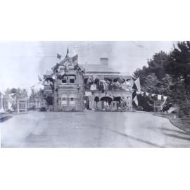 View of Saumarez Homestead covered with international flags