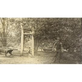 Unidentified man and young boy working in the gardens