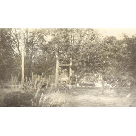 Unidentified man and young boy working in the gardens