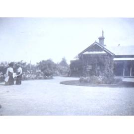View of Saumarez as a single storey house with two women in the foreground