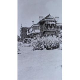 View of gardens with the homestead in the background