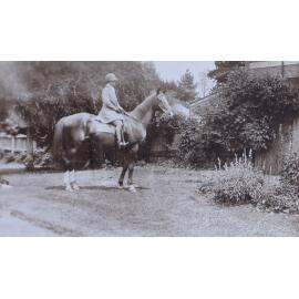 Unidentified woman on a horse in the gardens