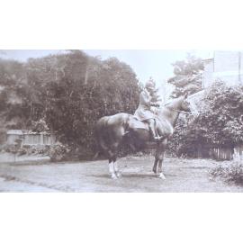 Unidentified woman on a horse in the gardens