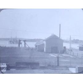 Unidentified harbour with ship leaving