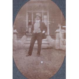 Unidentified man in front of a house