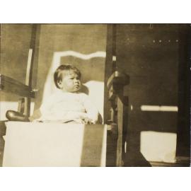 Small child sitting in a chair