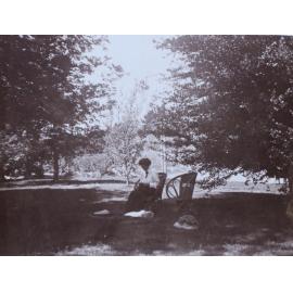 Unidentified woman sitting in the gardens