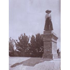 Unidentified woman standing on top of a chimney