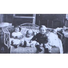 Four unidentified children on a lounge