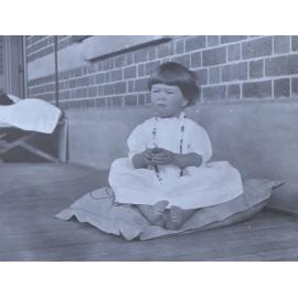 Unidentified girl sitting on a cushion