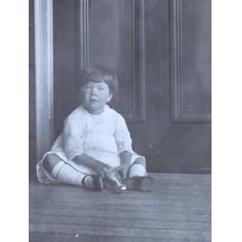 Unidentified girl sitting on the floor
