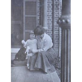 Unidentified woman and child with a pet dog