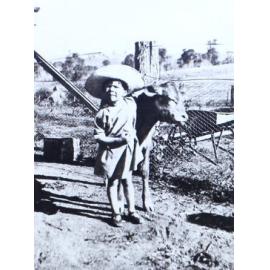 Unidentified child with calf