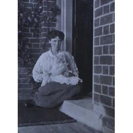 Unidentified woman cradling a baby