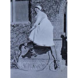 Unidentified woman on a penny farthing bicycle