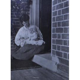 Unidentified woman cradling a baby