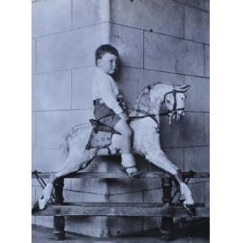 Unidentified young boy on a rocking horse