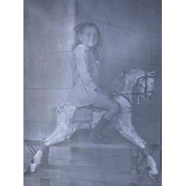 Young girl on a rocking horse