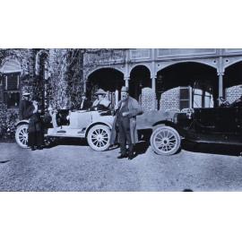 Two man, three women and two cars infront of Saumarez