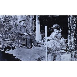 Unidentified man and woman sitting