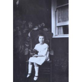 Young girl sitting on a chair with cat