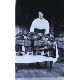 Unidentified woman with a table of knitted socks