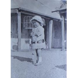 Young girl outside a house