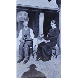 Unidentified man, woman, child and pet dog