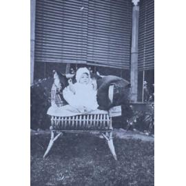 Baby sitting in a cane chair