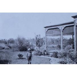 Young boy standing in the garden