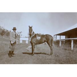 Unidentified man and saddled horse