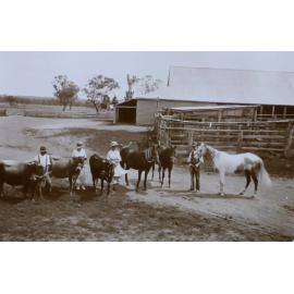 Men and women holding horses and cattle