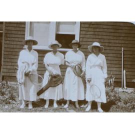 Four women in tennis outfits