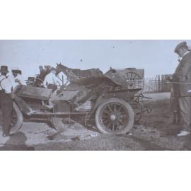 Men standing around a damaged car
