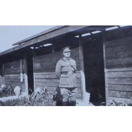 Officer outside timber huts