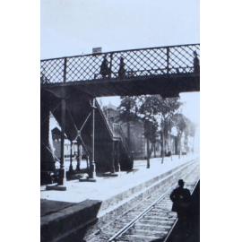 Railway platform with a footbridge over the rails