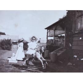Young girl riding a rocking horse