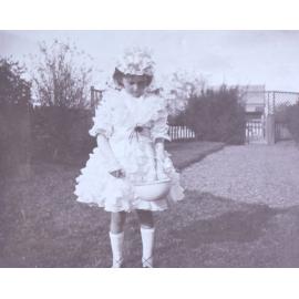 Girl dressed as Little Miss Muffet with bowl and spider