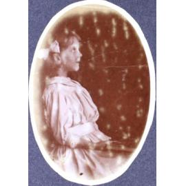 Young girl sitting - photo in profile