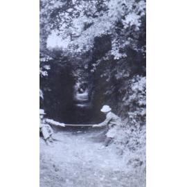 Two children playing on a pathway