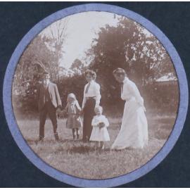 Unidentified man, two women and two young girls