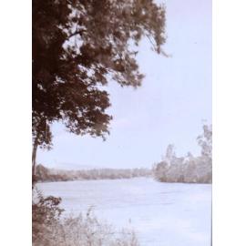 View down a river with buildings in the background