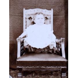 Small child sitting on a chair