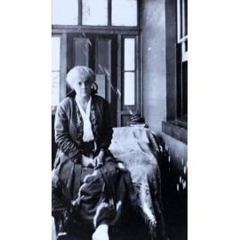 Woman sitting on the end of a day bed